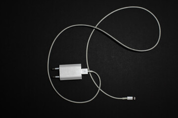 Lightning charger for phone on a black background