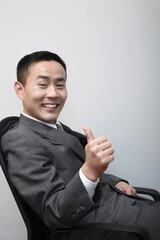 Businessman showing thumbs up