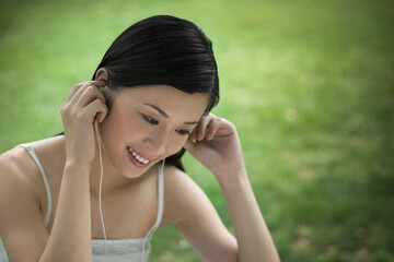 Woman smiling while listening to music on MP3 player