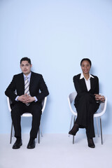 Businessman and businesswoman sitting on the chair