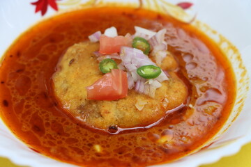 Kat vada, Kat wada or Batata vada sambar or Vada usal, spicy and tasty snack or breakfast, vada or potato patties served in a spicy sauce or curry, particularly in the marathi cuisine, Indian food