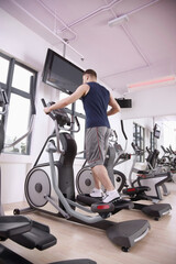 Obraz premium Man exercising on exercise bike
