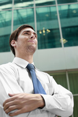 Businessman folding his arms while looking away