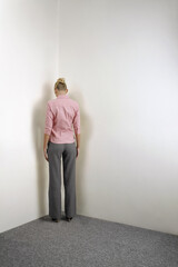 Businesswoman standing in corner of room