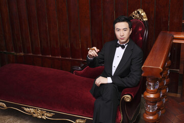 Man in tuxedo holding a cigar