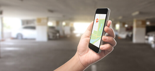 Hand holding smartphone device and touching screen, which is a red icon of the location, Concept of online navigation