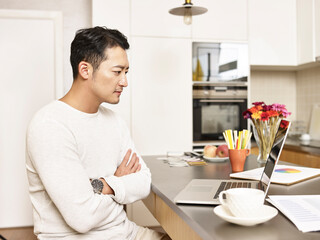 young asian business man working from home