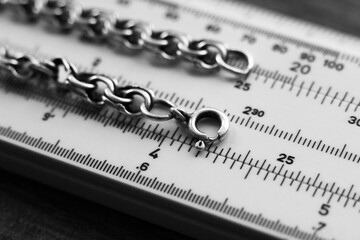Silver chain on the measuring device. - obrazy, fototapety, plakaty