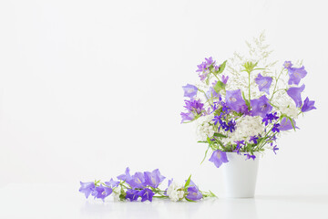 wild flowers in vase on white background