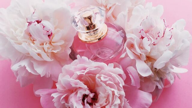 Pink perfume bottle with peony flowers, chic fragrance scent as luxury cosmetic, fashion and beauty product backgrounds
