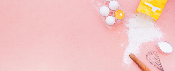 food banner, white eggs, a wooden rolling pin, a metal whisk and scattered flour from a yellow bag on a delicate pink background. kitchen utensils for baking