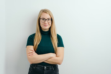 Self-assured young woman with crossed arms