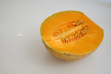 High angle view of orange melon against a white background