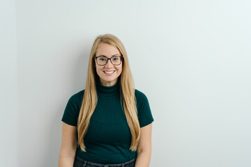 Friendly happy young blond woman in glasses