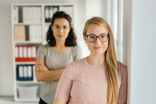 Two young businesswoman stood in modern office