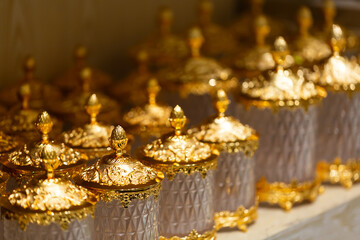 Openwork festive golden vase on a table is the background selective focus and shallow depth of field. Close up