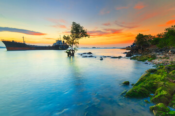Fototapeta na wymiar Tangker and barge in sunset on beach Batam island