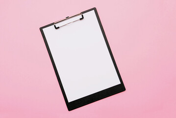 Medical folder with white blank page on pink background.