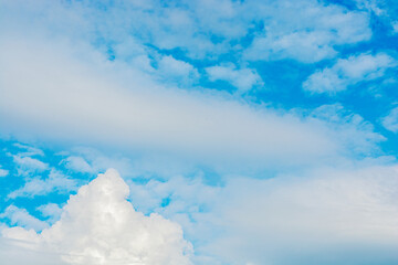 In the blue sky there are white fluffy clouds of amazing shape.