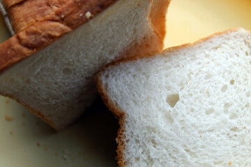 Brown white color raw bread pieces cropped and partial display with selective focus. Food background.
