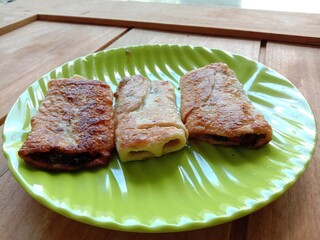 View of three kebab on green plate. Food from meat. 