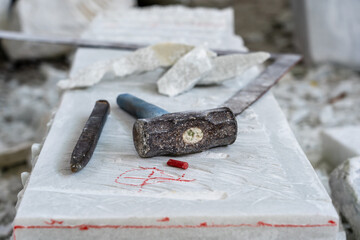 Sculptor tools on a marble slab, close up. Workplace, traditional tools sculptor, red chalk, ruler,...