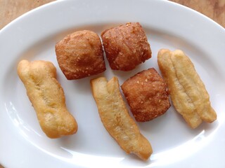 Cakue is favorite meals from Indonesia. Food on white plate with wooden background