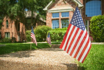 American flags displayed in the front of a southern home in honor of the 4th of July - 363111987