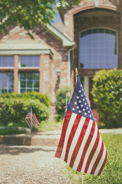 American flags displayed in the front of a southern home in honor of the 4th of July