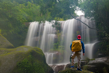 Male tourist With backpacks The beautiful waterfall