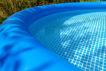 Part of a blue inflatable pool in the backyard of a private house.
