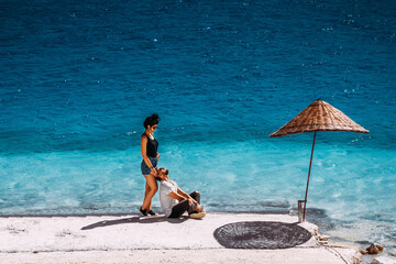 Couple in love in the Blue lagoon. Man and woman on the coast in Turkey. Man and woman on the island. Couple on vacation. Lovers at the lake in the mountains. Happy couple on the beach. Copy space