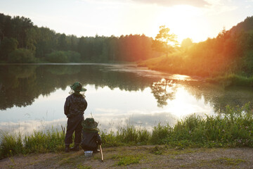 Obraz na płótnie Canvas two boys fishing at sunset