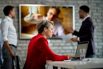 Fototapeta premium Businesswoman working on laptop during a meeting in the office.