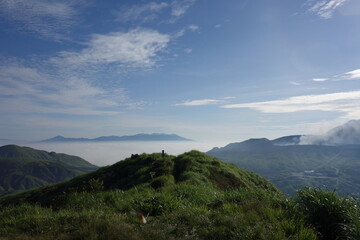 Obraz premium Mt.Kuju range on sea of clouds and small eruption of Mt.Aso from top of Mt.Eboshi