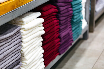 Pile of new towels in shop on a regiment, shallow depth of field, texture background.