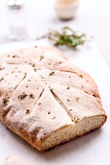 Homemade fresh baked Fougasse (French Bread) with thyme and olive oil on white background. Traditional Provencal dishes. Selective focus
