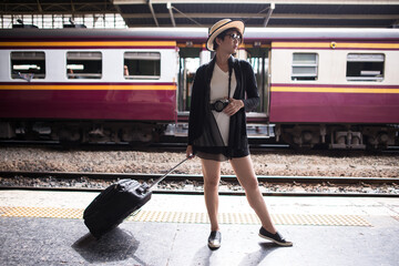 asian girl waiting train near track