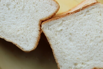 Brown white color raw bread pieces cropped and partial display with selective focus. Food background.