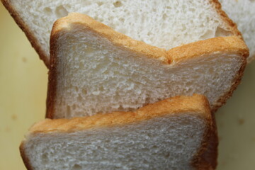 Brown white color raw bread pieces cropped and partial display with selective focus. Food background.