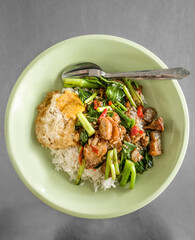 stir fried chinese kale with crispy pork with fried egg