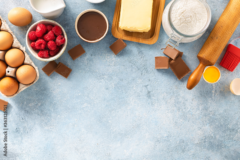 Poster Ingredients for cooking raspberries and chocolate pie with copy space top view Bakery background