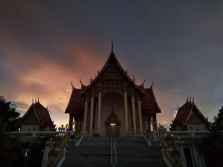 Fototapeta premium view evening of Buddhist temple with twilight sky background, Wat Don Toom, Ban Pong, Ratchaburi, Thailand.