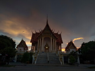 Fototapeta premium view evening of Buddhist temple with twilight sky background, Wat Don Toom, Ban Pong, Ratchaburi, Thailand.