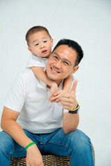 Little kid hanging on his father back