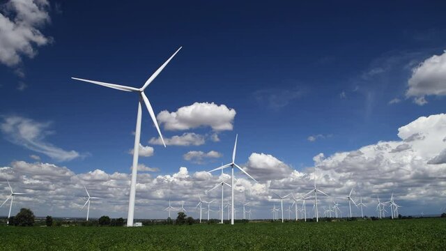 Windmills for electric power production with white cloud and blue sky at Huai Bong, Dan Khun Thot district, Nakhon Ratchasima THAILAND. renewable energy and save  environmental concept