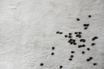 A top view of a delicious coffee in a cup near the roasted beans spread on a white background.Top view with copyspace for your text.