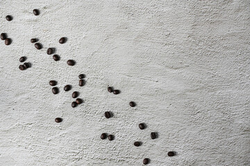 A top view of a delicious coffee in a cup near the roasted beans spread on a white background.Top view with copyspace for your text.