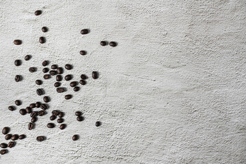 A top view of a delicious coffee in a cup near the roasted beans spread on a white background.Top view with copyspace for your text.