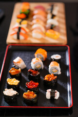 nigiri sushi maki on wooden tray